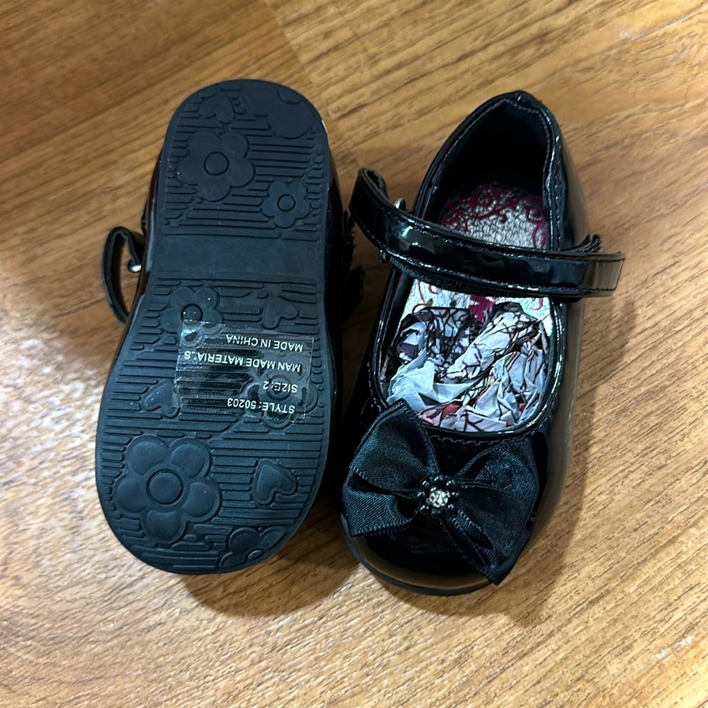 Brand new. Black patten baby shoes
